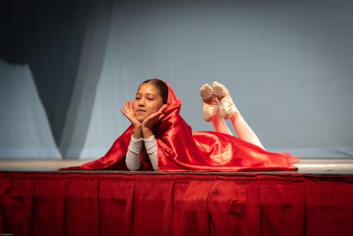Girl in a Red Hood Lying on the Stage