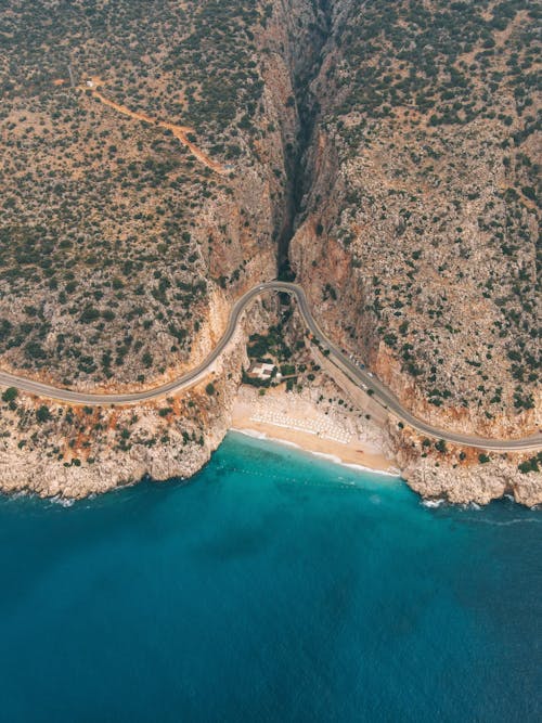 Aerial Footage of Textured Cliffs, and Turquoise Sea