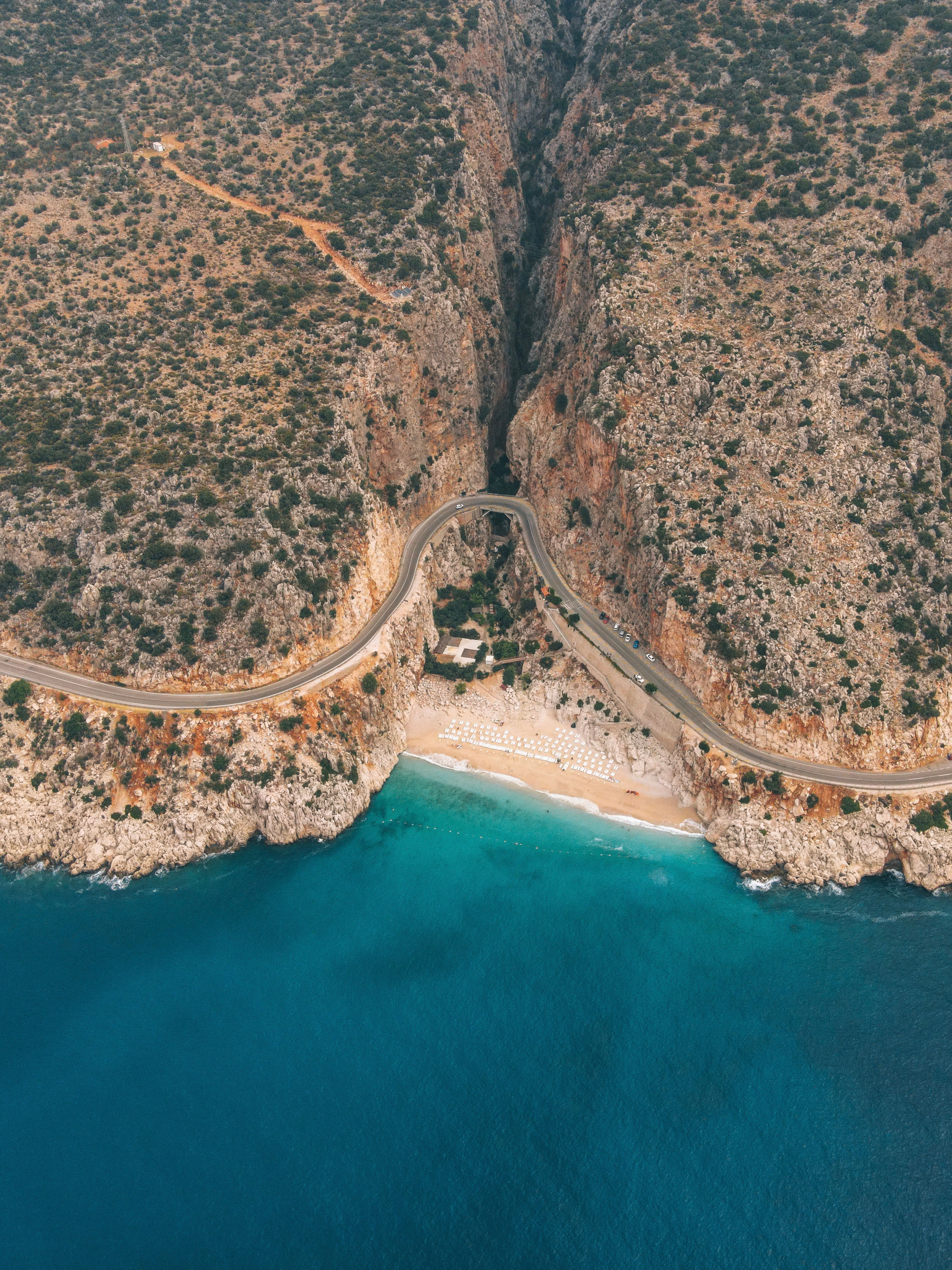 Aerial Footage of Textured Cliffs, and Turquoise Sea · Free Stock Photo