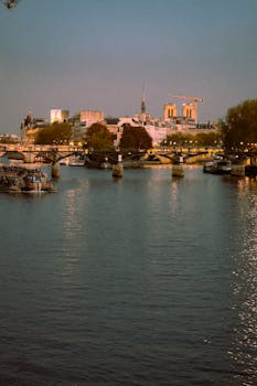 Scenic view of Notre Dame and River Seine at twilight with reflections in Paris, France.