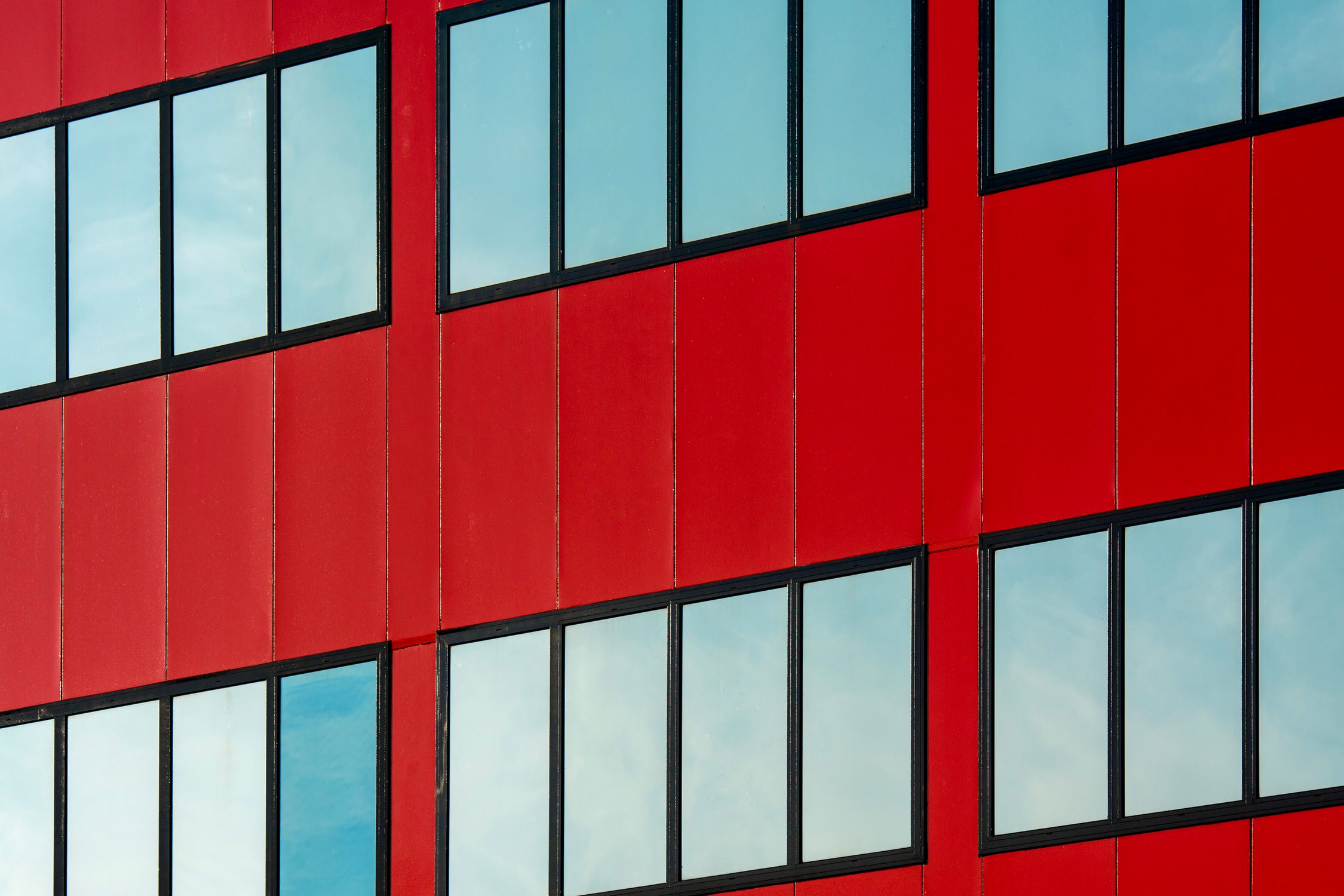 Closeup of a Red Building Facade with Simple Windows · Free Stock Photo