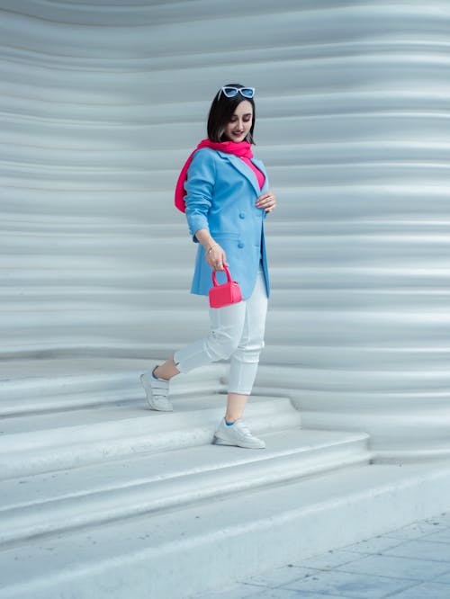 Pretty Woman in Blue Jacket on White Stairs