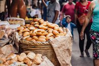 Fresh bread rolls in a bustling Yurimaguas market setting, highlighting local culture.