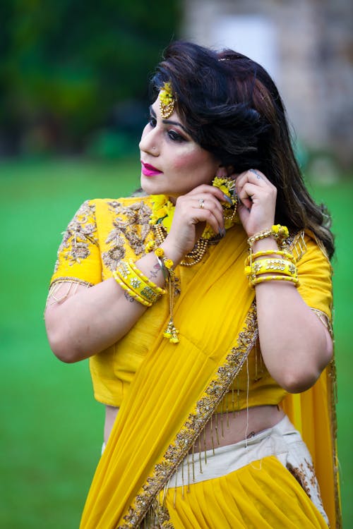 Standing Woman in Yellow Saree