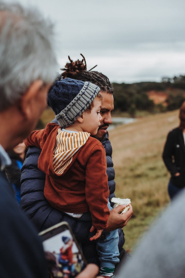 Photo Of A Man Holding A Boy In His Arms