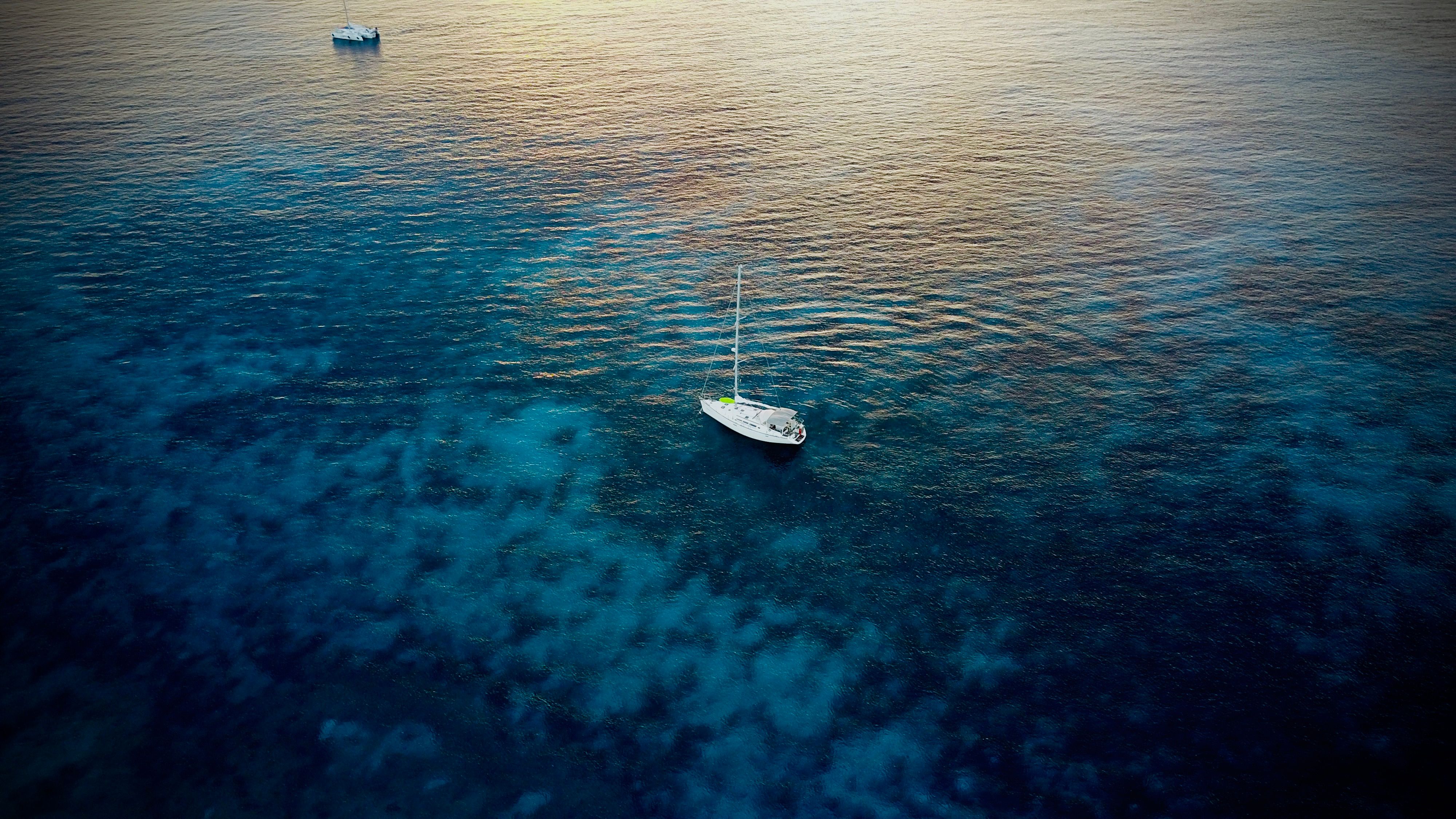 Outstanding Full Day Sport Fishing Charter Honolulu Review: 8 Hours of Luxury Fishing on Oahu's Waters Review 2026 - Peaceful aerial view of sailboats on the serene blue sea near Q.R., México at sunset.