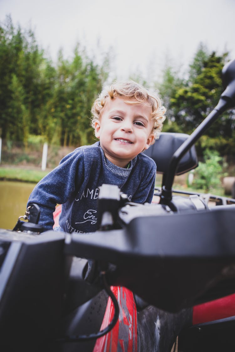 Smiling Boy Posing On Bike