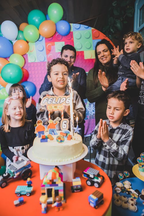 Free Smiling Children Celebrating Birthday with Cake Stock Photo