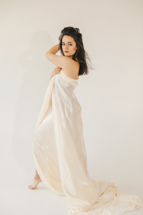 Brunette Woman Covered with Satin Blanket
