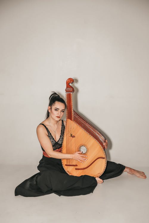 Brunette Woman Posing with Bandura Instrument