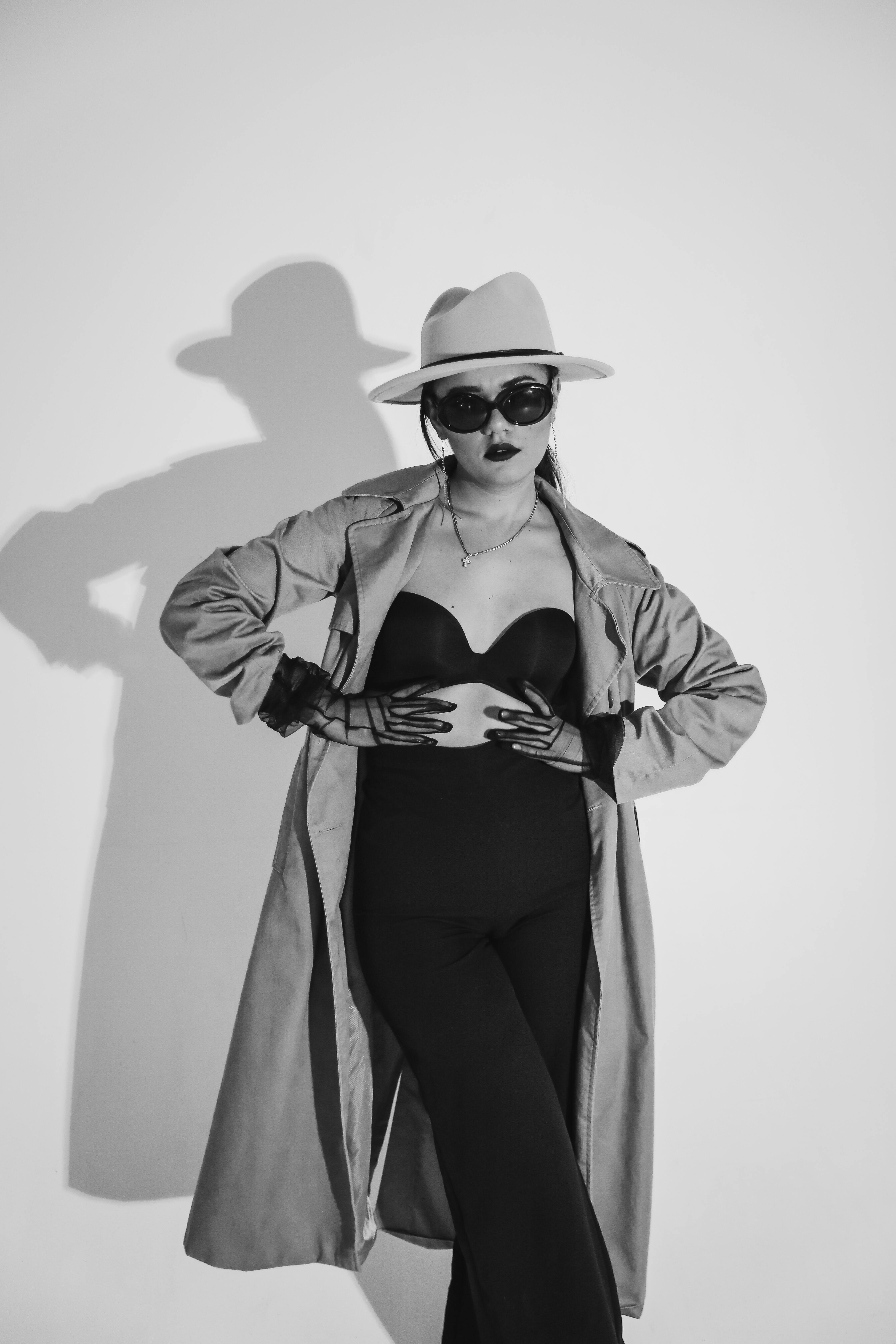 Free Chic woman in stylish black and white attire, exuding elegance and glamour in a studio setting. Stock Photo