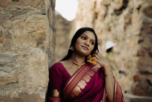 Free A beautiful portrait of a woman wearing traditional Indian sari, smiling gracefully. Stock Photo