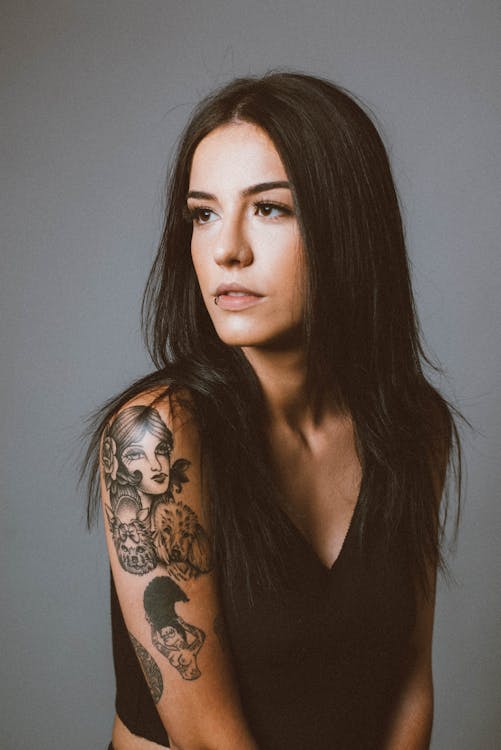 Studio Portrait of a Young Brunette with Tattoos · Free Stock Photo