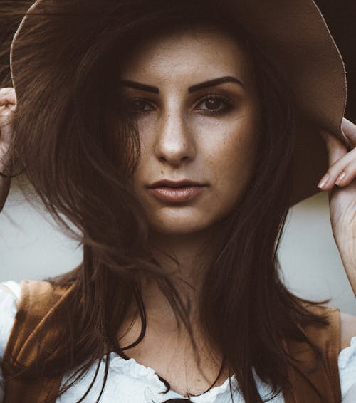 Portrait of a Young Brunette Wearing a Hat 