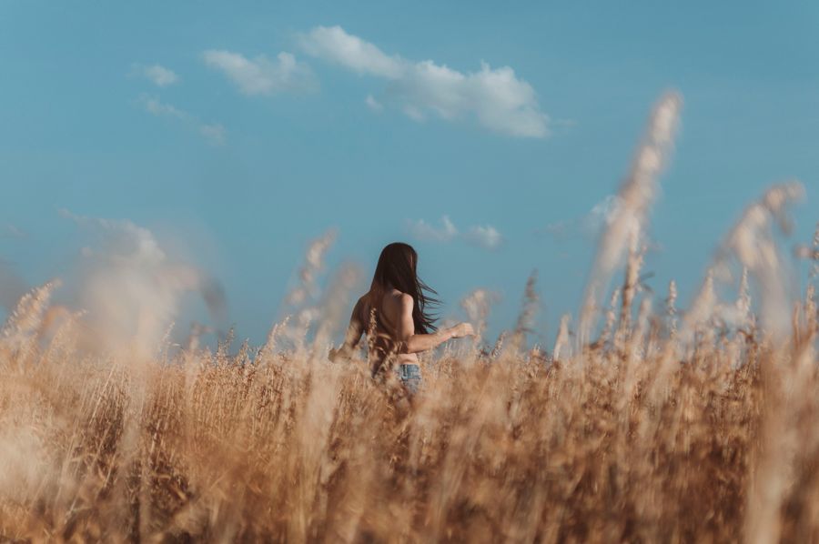 Person walking freely through a sunny field, pain-free life after DVPSI treatment