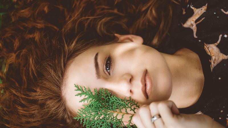 A Woman Covering Her Face With Green Leaves · Free Stock Photo