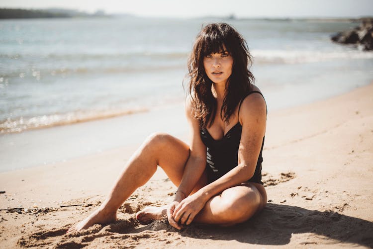 Brunette With Bangs At Beach In Swimming Costume