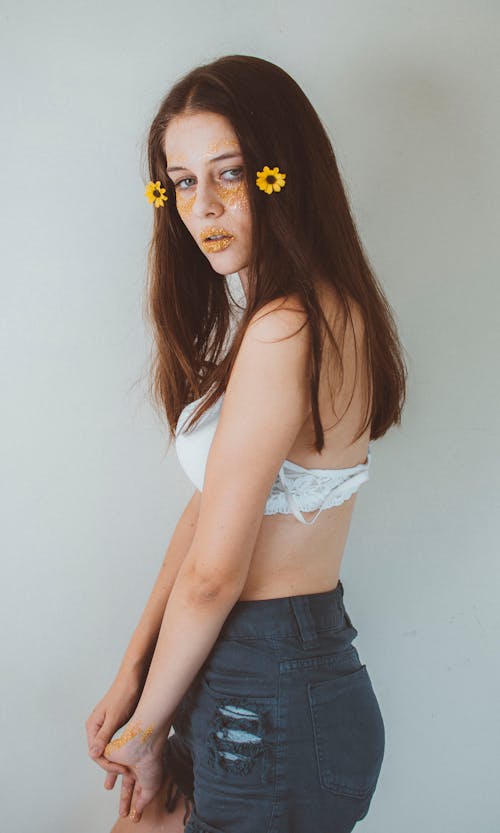 Young Woman in a Bra and Jeans Standing with her Arms Raised · Free Stock  Photo