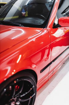 Close-up of a shiny red sports car interior and exterior with a reflection.