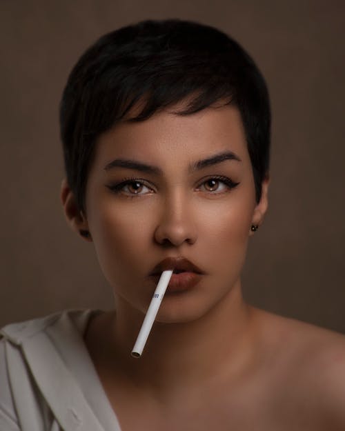 Portrait of Young Woman with Cigarette in Studio