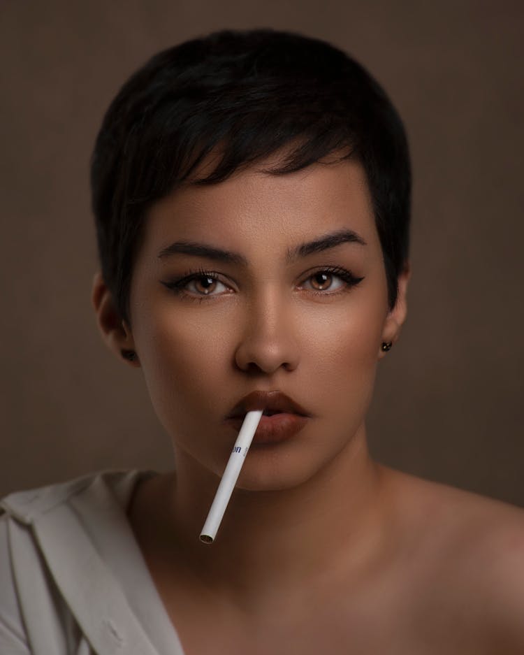 Portrait Of Young Woman With Cigarette In Studio