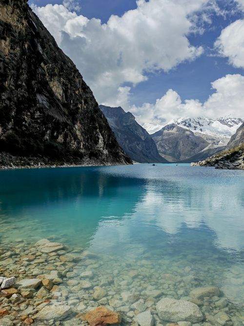 Free Breathtaking turquoise lake in Huaraz, Peru with surrounding Andes mountains. Stock Photo