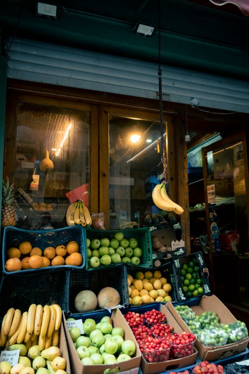 Free Colorful assortment of fruits at an outdoor street market stand in an urban setting. Stock Photo
