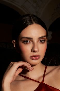 Glamorous portrait of a young woman posing confidently, highlighting beauty and fashion.