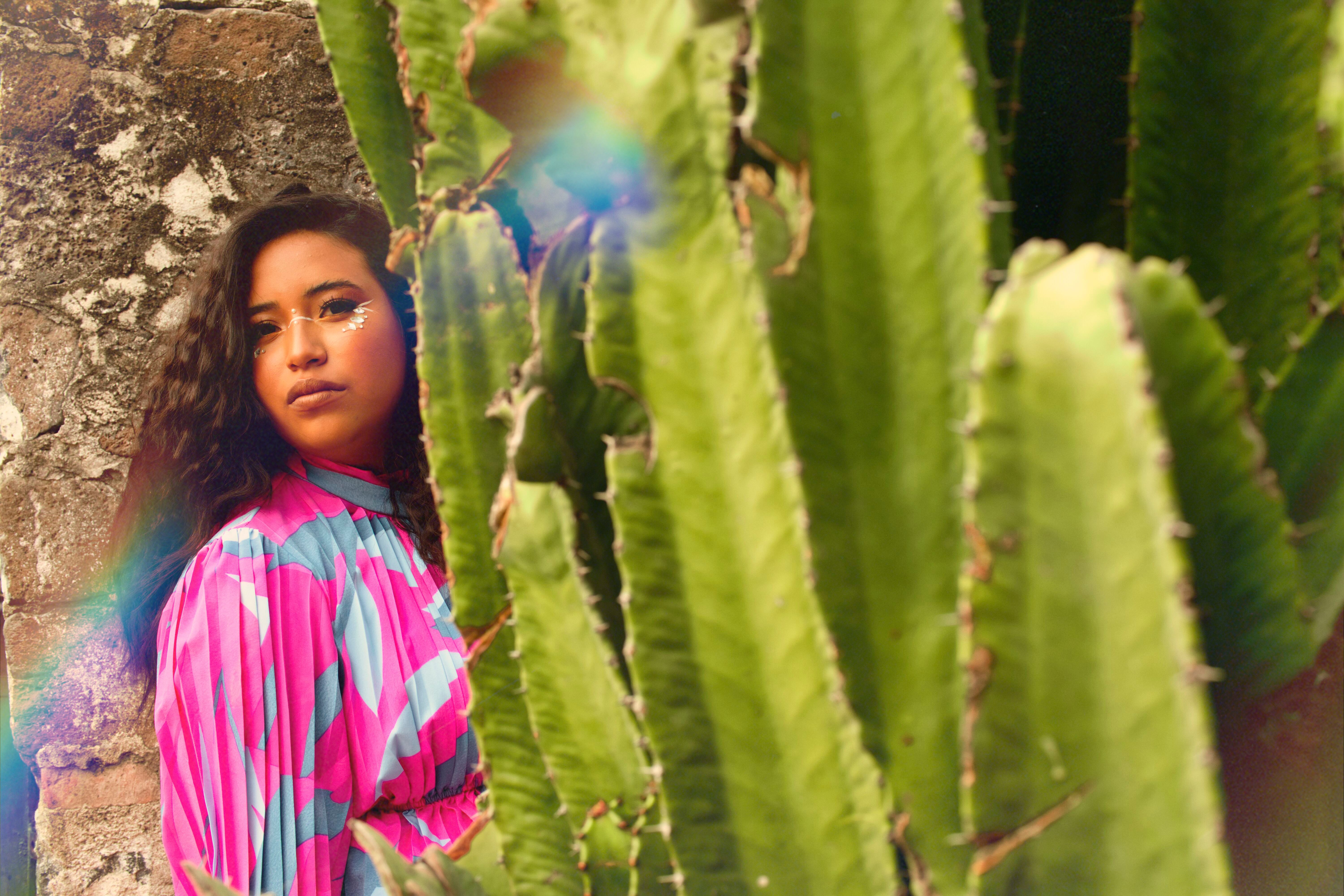 Woman Standing next to a Cactus  Free Stock Photo