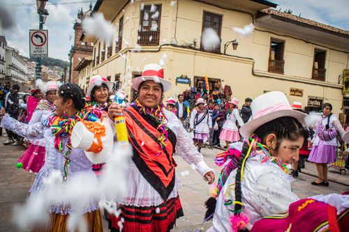 Free Colorful street festival featuring traditional dancers in lively costumes and festive atmosphere. Stock Photo