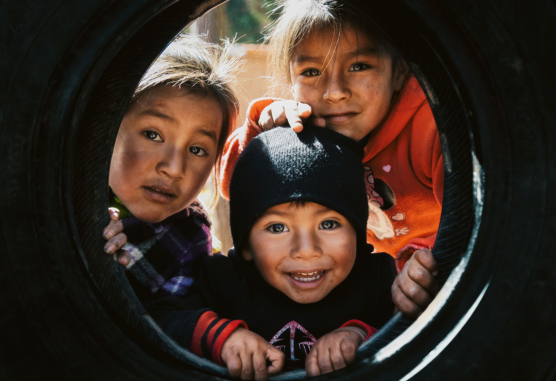 Kids Looking through a Tire Swing