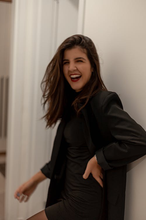 Young Woman in an Elegant Black Outfit Laughing 