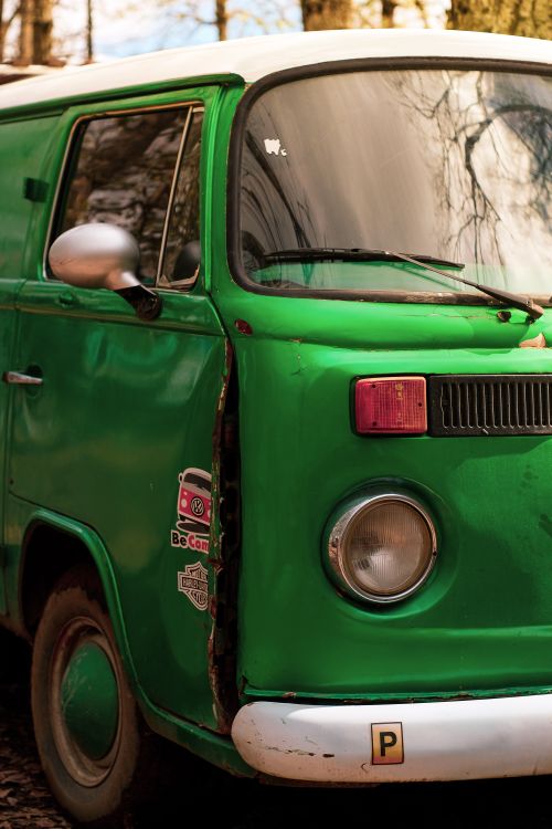 Free A classic green Volkswagen van parked outdoors, capturing a retro vibe. Stock Photo