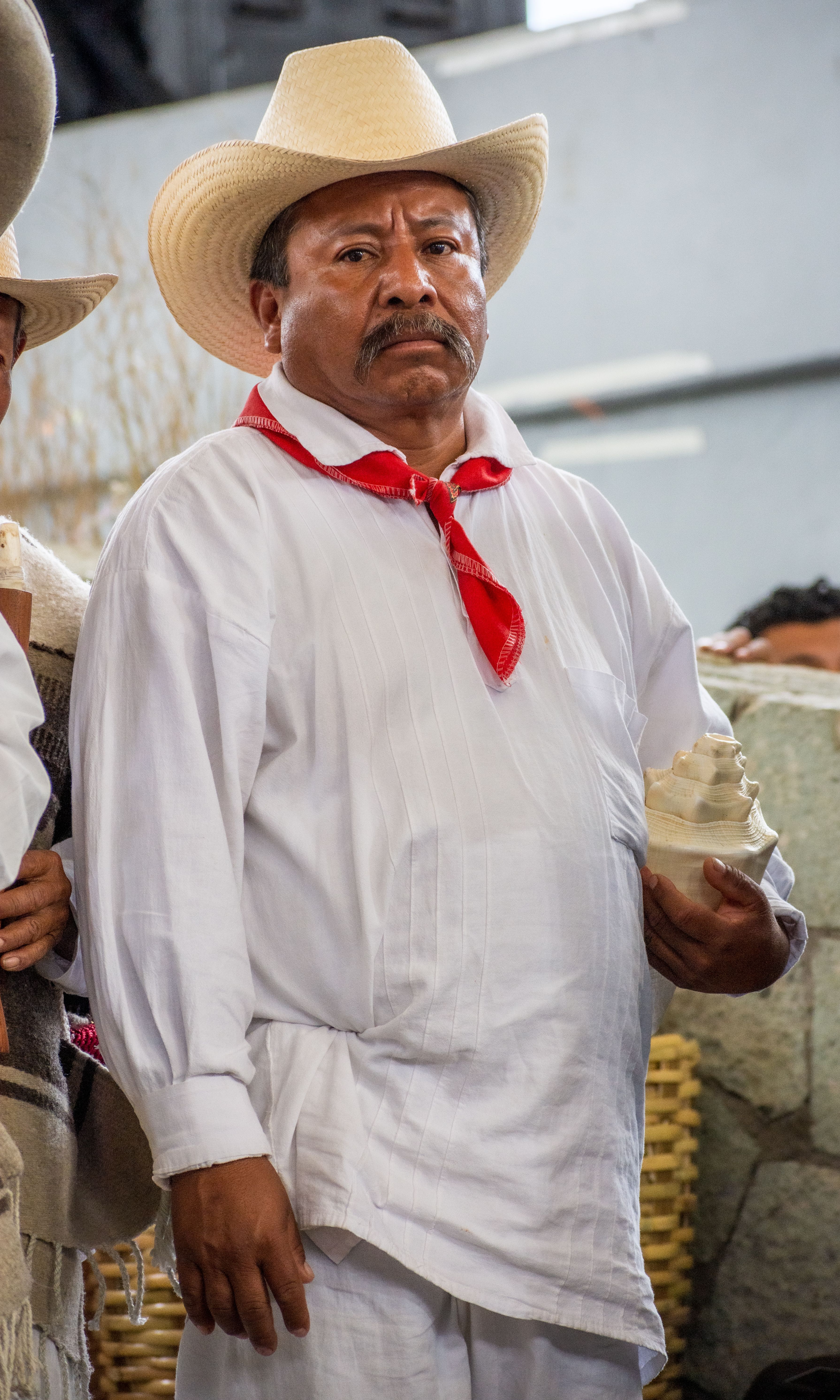 Man in traditional Mexican attire at a cultural event, showcasing heritage and tradition.