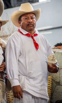 Man in traditional Mexican attire at a cultural event, showcasing heritage and tradition.