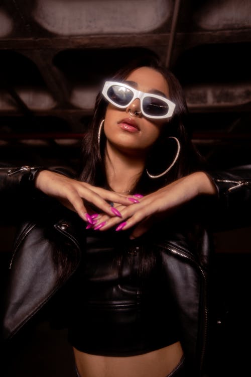 Young Woman in a Leather Jacket and Sunglasses 