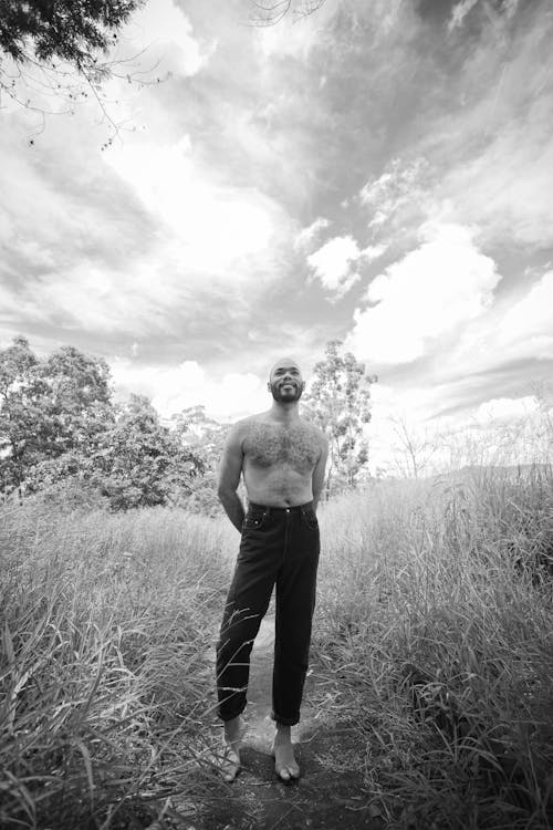 Topless Man on Grassland in Black and White