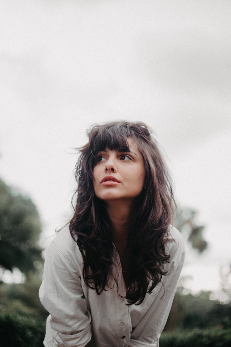 Young Brunette With Bangs Standing Outdoors 