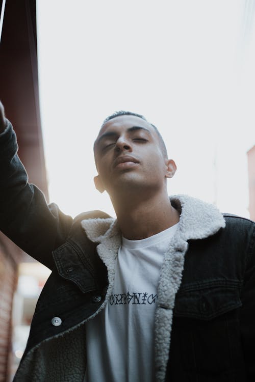 Young Man in Casual Trendy Clothes Standing in an Urban Area 