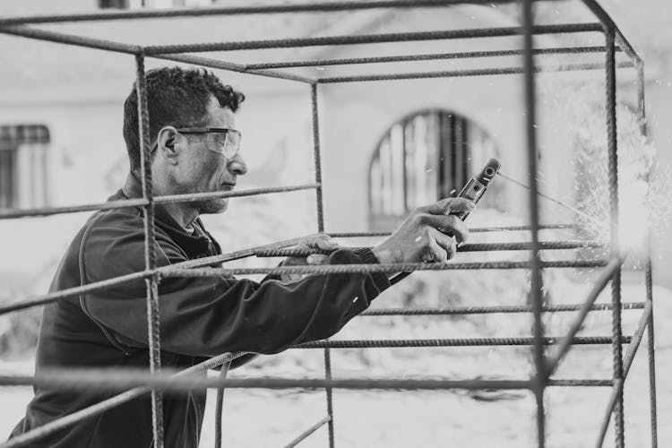 Man Welds A Cage Of Reinforcing Bars