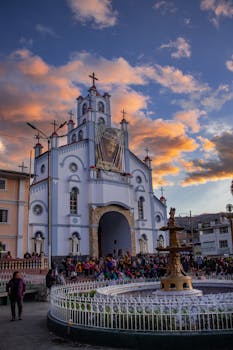 Stunning view of a church and fountain in Huaraz, Peru during sunset.