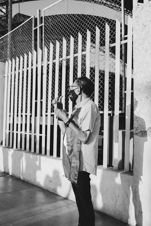 Candid Picture of a Man in a Face Mask on the Sidewalk 