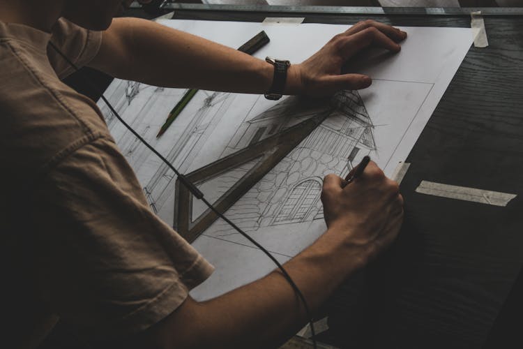 Closeup Of A Man Drawing Architecture