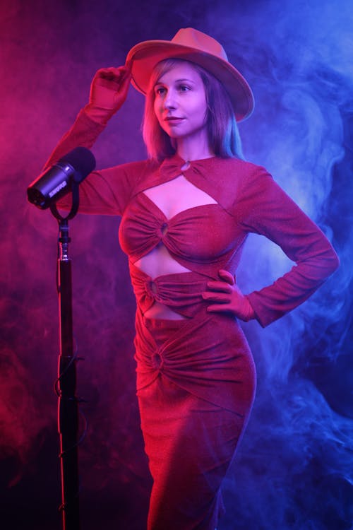 Woman in Dress next to Microphone