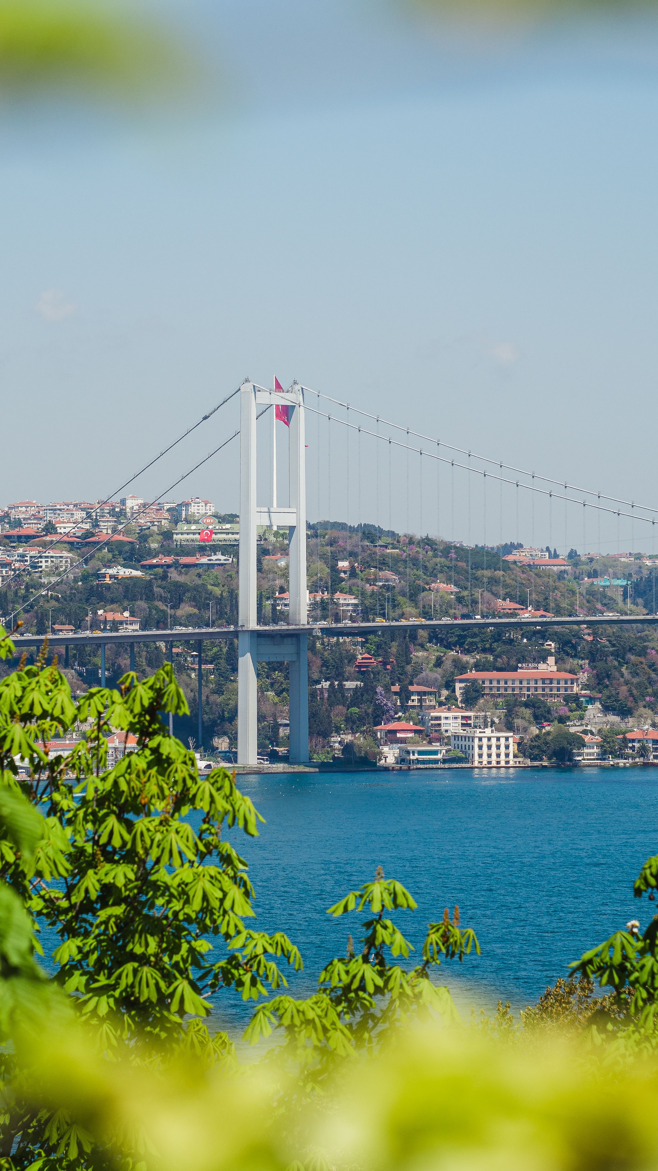 A clear summer view of Fatih Sultan Mehmet Bridge spanning the Bosphorus Strait in Istanbul.