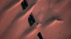 无人机在迪拜拍摄到部分被沙丘覆盖的孤立道路，展现了广阔的沙漠和废弃的基础设施