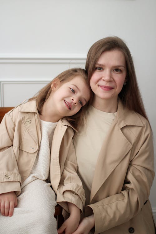 Portrait of a Woman and a Daughter Wearing Beige Coats