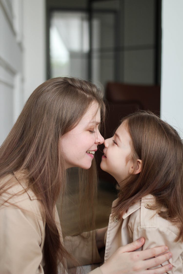 Mother And A Daughter Touching Each Others Noses