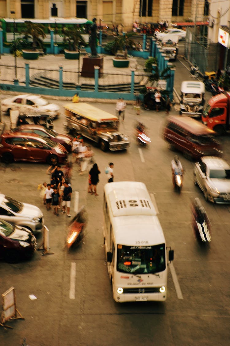 Cars Driving On City Street On Sunset