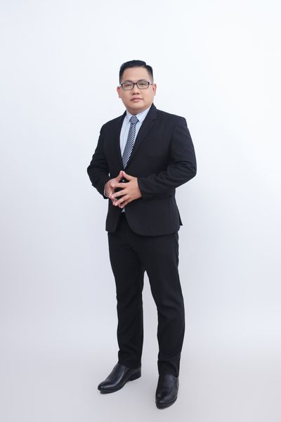 Man in a two-piece suit and tie — photo by Tran Nhu Tuan on Pexels